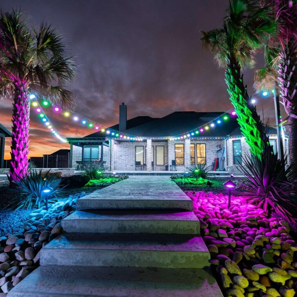 Home and front walkway with multicolor permanent lights at night