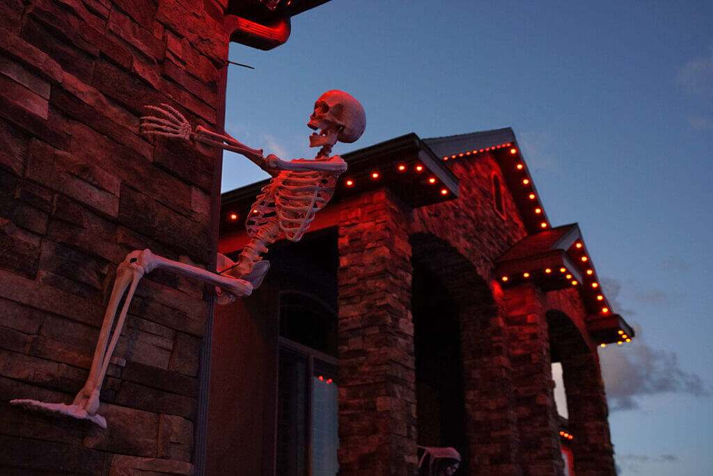 Home with orange and red Halloween permanent lights