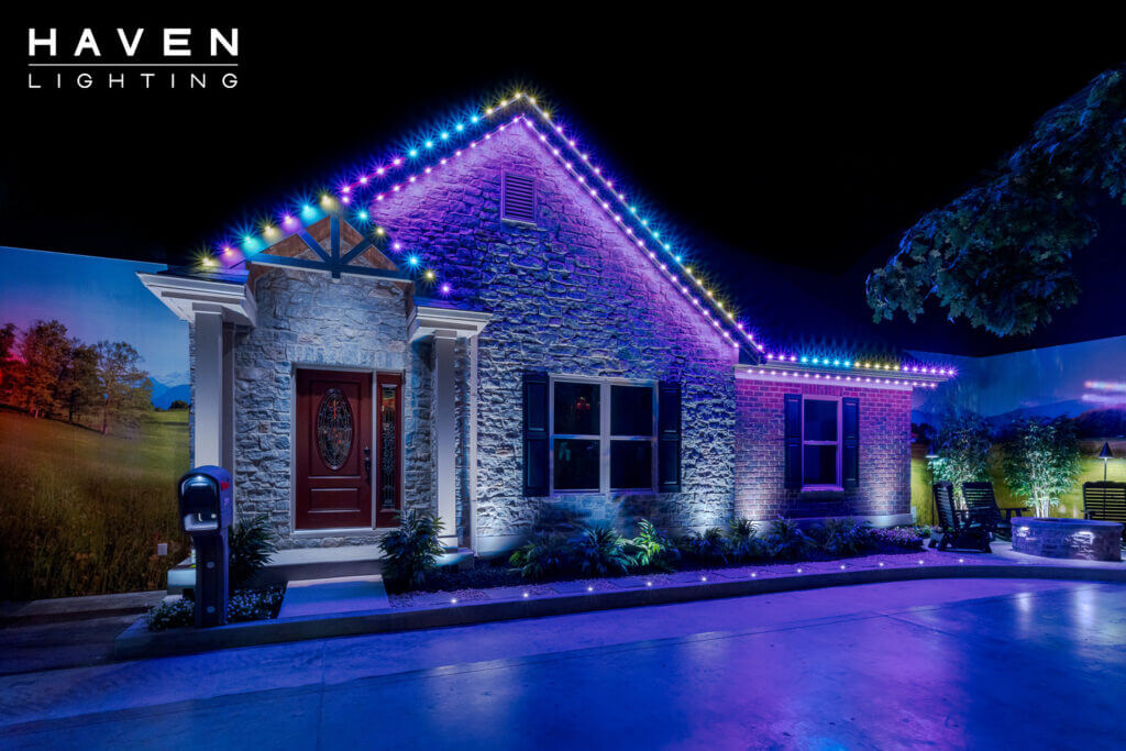 Single-story showroom home with blue & white permanent roofline and landscape lighting