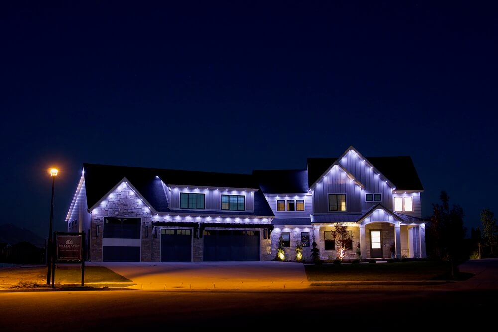 Home with blue and white JellyFish permanent roofline lights