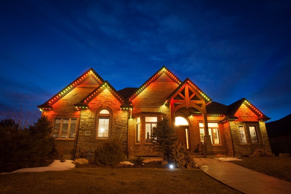 Home with orange and amber JellyFish permanent roofline lights