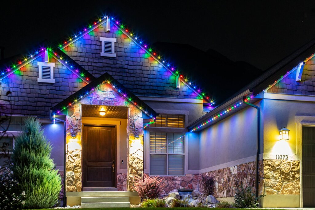 Home front entry with blue and white Christmas permanent lights