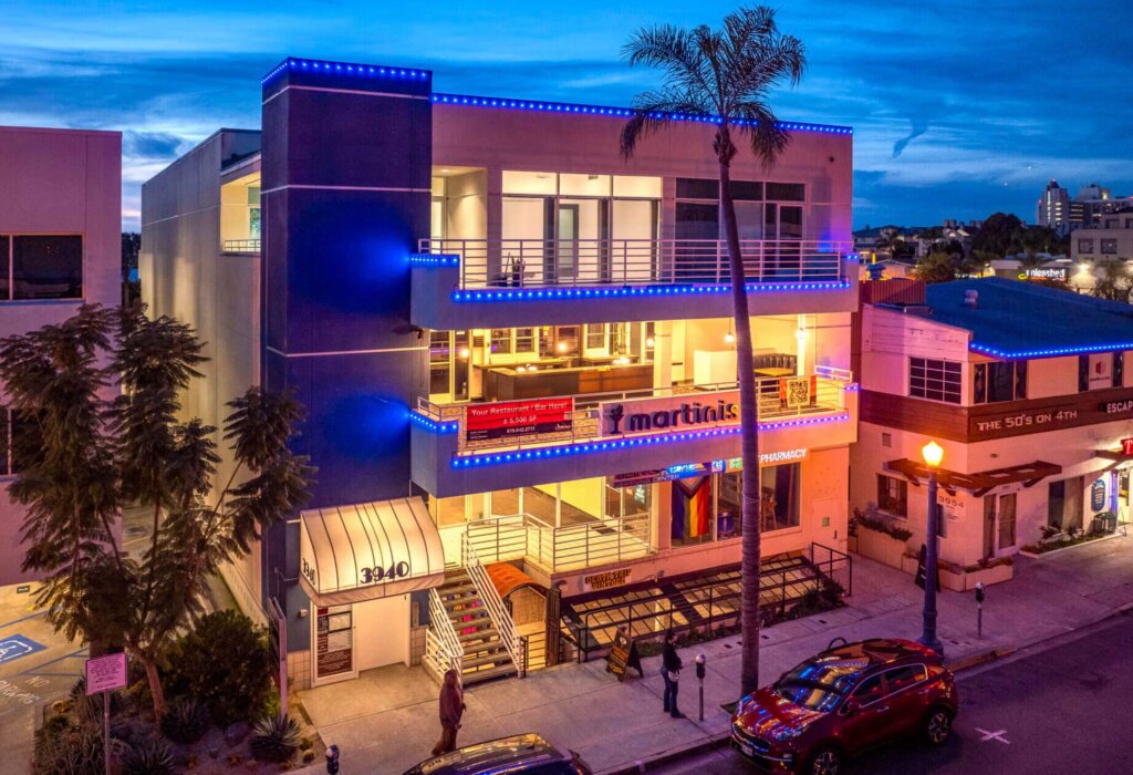 Mixed-use building with commercial LED lighting at dusk