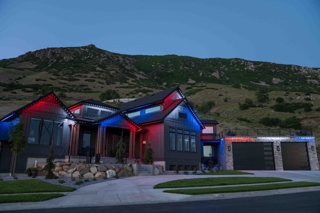 Game day red blue mountain home with permanent outdoor lighting
