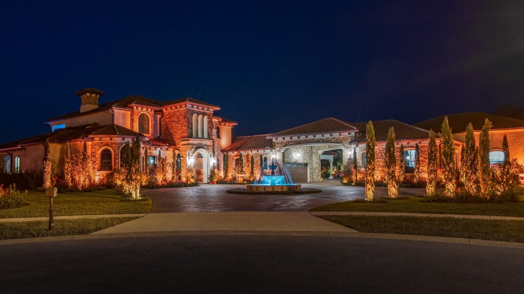 Estate exterior with warm orange permanent lighting at night
