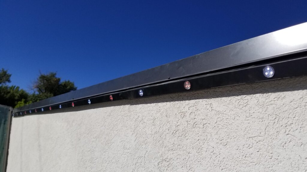 Permanent light track installed on a home fascia in daylight