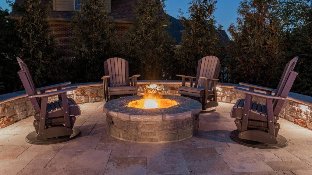 Backyard fire pit lounge with permanent accent lighting